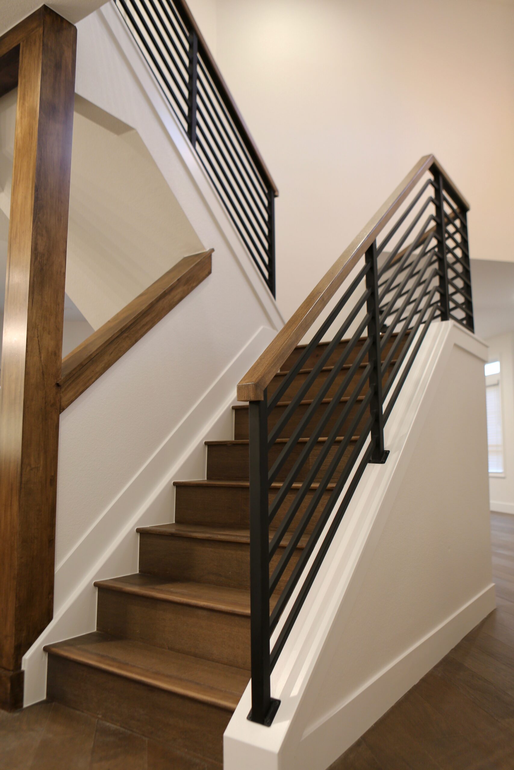 Staircase featuring wood steps and metal handrails